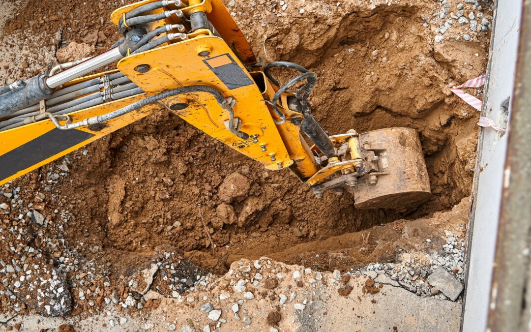 Bucket,Of,Modern,Yellow,Excavator,Digs,Deep,Pit,To,Change